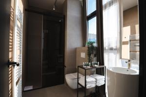 a bathroom with a toilet and a sink and a mirror at DISTRICT boutique in Osijek +85 photos