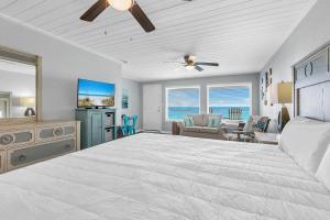 a bedroom with a large bed and a living room at The Shores Townhome #116 in Carillon Beach +36 photos