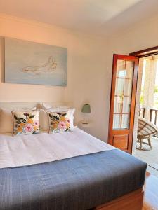 a bedroom with a large bed with pillows at Casa da Touça in Arcos de Valdevez