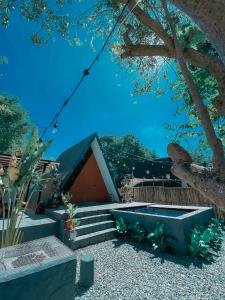 a small house with stairs leading to a building at Private Cabin with pool close to the Beach in Bolinao