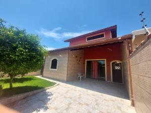a house with a patio in front of it at Casa Praia Peruibe in Peruíbe