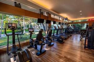 a gym with a bunch of treadmills and ellipticals at Gloria Golf Resort in Belek