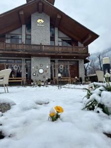 a house with snow in front of it at Amarys Boutique Stays Manali in Manāli