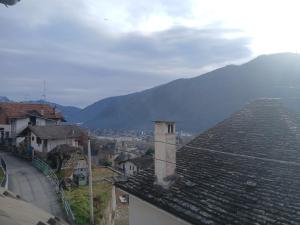 a view of a town with mountains in the background at La mansarda del cervo in Santa Maria Maggiore