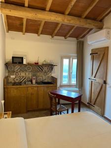 a living room with a table and a kitchen at Camera tripla Il Picchio Verde in Altopascio