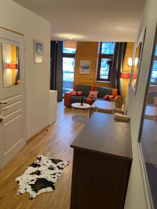 a living room with a couch and a table at Chamrousse Residence le Balcon de Recoin - Au pied des pistes in Chamrousse