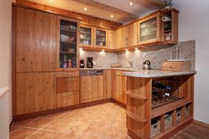 a kitchen with wooden cabinets and a counter top at Traum in Nauders