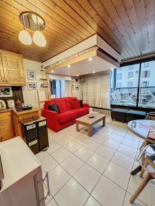 a living room with a red couch and a table at Ladybird Inn in Chamonix-Mont-Blanc