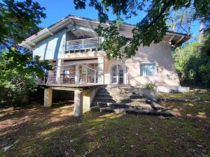 a house with a large porch and a balcony at Villa PERICA pour 10 personnes. Entre lac et océan. Wifi gratuit. in Soorts-Hossegor