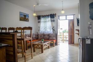 a living room with a couch and a table at Pendo Cottages in Kwale