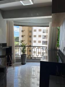 a large room with a view of a building at Belíssimo Apto Setor Bueno in Goiânia