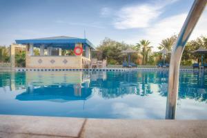 a pool at a resort with a lifeguard station at Mangrove Bay Resort in Quseir