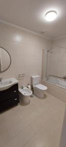 a bathroom with a toilet and a sink and a tub at Férias de Sonho in Arcos de Valdevez +18 photos