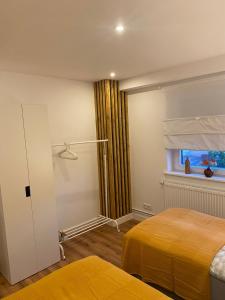 a bedroom with two beds and a window at Ferienwohnung Burgunderwiese in Bad Neuenahr-Ahrweiler
