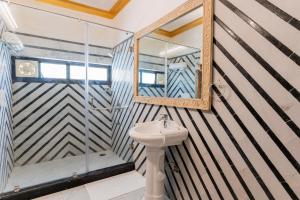 a bathroom with a sink and a shower at Wanderlust A Boutique Homestay in Udaipur +37 photos