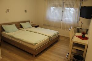 Postel nebo postele na pokoji v ubytování Hotel Garni Postkutsche
