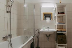 a bathroom with a sink and a tub and a shower at Große Ferienwohnung Burgenland in Eisenstadt +39 photos