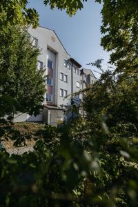 a building with a lot of trees in front of it at Große Ferienwohnung Burgenland in Eisenstadt