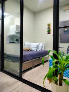 Ένα ή περισσότερα κρεβάτια σε δωμάτιο στο 2 BEDROOM CONDO close to SM Tungko BULACAN ideal for Family Queen bed on Bedroom 1 accessible to Bedroom 2 with sliding doors Free Wifi & Netflix to watch in a comfy sofa & twin bed Access to SWIMMING POOL entry is very affordable and kids get for free
