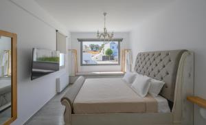 a bedroom with a large bed and a window at Marvarit Villas in Vóthon