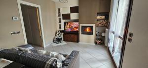 a living room with a couch and a tv at Holiday home Tavullia in Tavullia