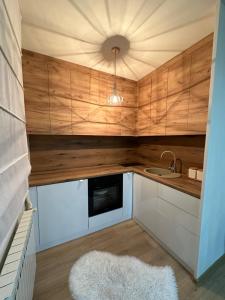 a small kitchen with wooden cabinets and a sink at Apartment Story in Pale