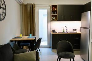 a kitchen with a table and chairs and a refrigerator at Elaion guest house in Athens