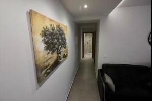 a hallway with a painting hanging on a wall at Elaion guest house in Athens +15 photos