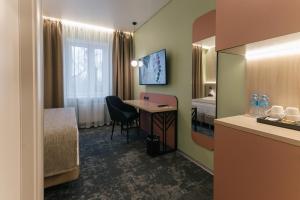 a hotel room with a table and a room at Yourta in Oral