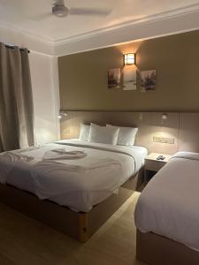 a hotel room with two beds and a window at The G Ten Holiday Inn in Hulhumale +5 photos