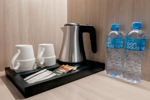 a coffee maker and two bottles of water on a counter at Yourta in Oral