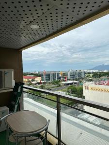 a balcony with a table and a view of a city at Angeles City Apartment in Santol +40 photos
