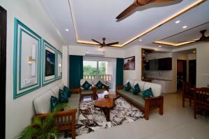a living room with a couch and a table at Tranquil Trails- Holiday Homes-Dehradun in Dehradun