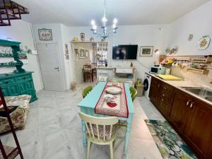 a kitchen with a blue table and a kitchen with a sink at Guardiagrele-Non ti scordar di me in Guardiagrele