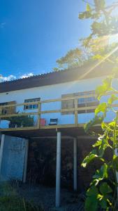un edificio con una terraza de madera delante de él en Cabana Solitude - Concha, en Florianópolis