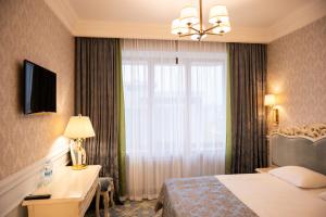 Postel nebo postele na pokoji v ubytování Olympic Hotel