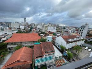 an overhead view of a city with buildings and roofs at Amy Hotel Hue in Hue