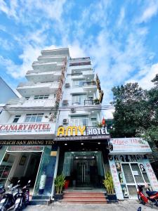 a large white building with a sign on it at Amy Hotel Hue in Hue