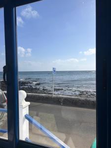 a view of the ocean from a window at Casa maría in Costa Teguise