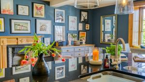 a kitchen with blue walls and a sink and a fireplace at Ty Castell in Beaumaris +65 photos