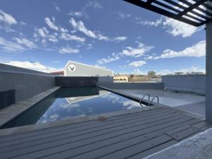 a swimming pool on the roof of a house at C&J Luxe Apartments in Windhoek