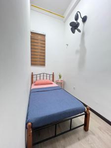 a bedroom with a bed in a white room at CasaPutra by MySky Stays Putrajaya in Putrajaya