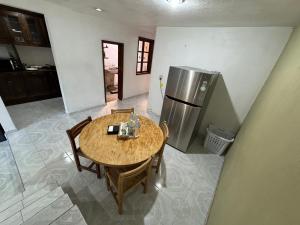 a kitchen with a wooden table and a refrigerator at Un lugar muy bien ubicado in Morelia