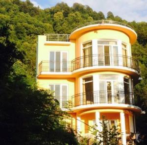 a yellow house on the side of a hill at Villa Royal Realm in Batumi