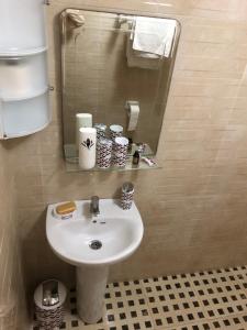 a bathroom with a white sink and a mirror at Hagounia hotel in Tan-Tan Plage +108 photos