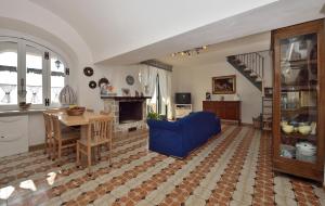 a living room with a blue couch and a table at Casa Barbara in Amalfi
