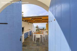 a kitchen and dining room with a table and chairs at BLUE CORAL BEACH VILLAS three exclusive villas - Poseidon - Nautilus - Oceanos - and - Baby Coral bungalow in Coral Bay