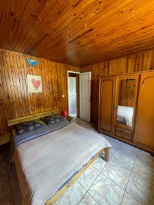 a bedroom with a large bed in a wooden room at Marie Begue Villa in Cilaos