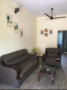 a living room with a couch and a table at Cloud 9 Residency in Dehradun