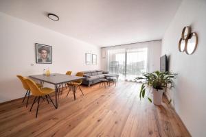 a living room with a table and chairs and a couch at Apartment Caldara 4 in Pianizza di Sotto